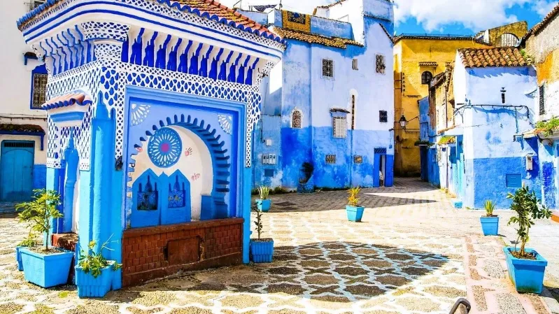 1. A stunning view of Chefchaouen, Morocco, showcasing its iconic blue-washed buildings and picturesque mountain backdrop while your trips in Morocco