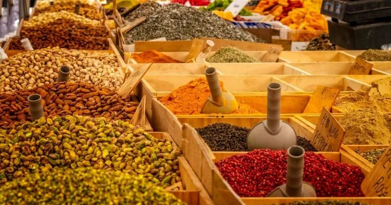 A collection of spices and herbs arranged in wooden crates, showcasing a vibrant array of colors and textures: Cuisine of Moroccon